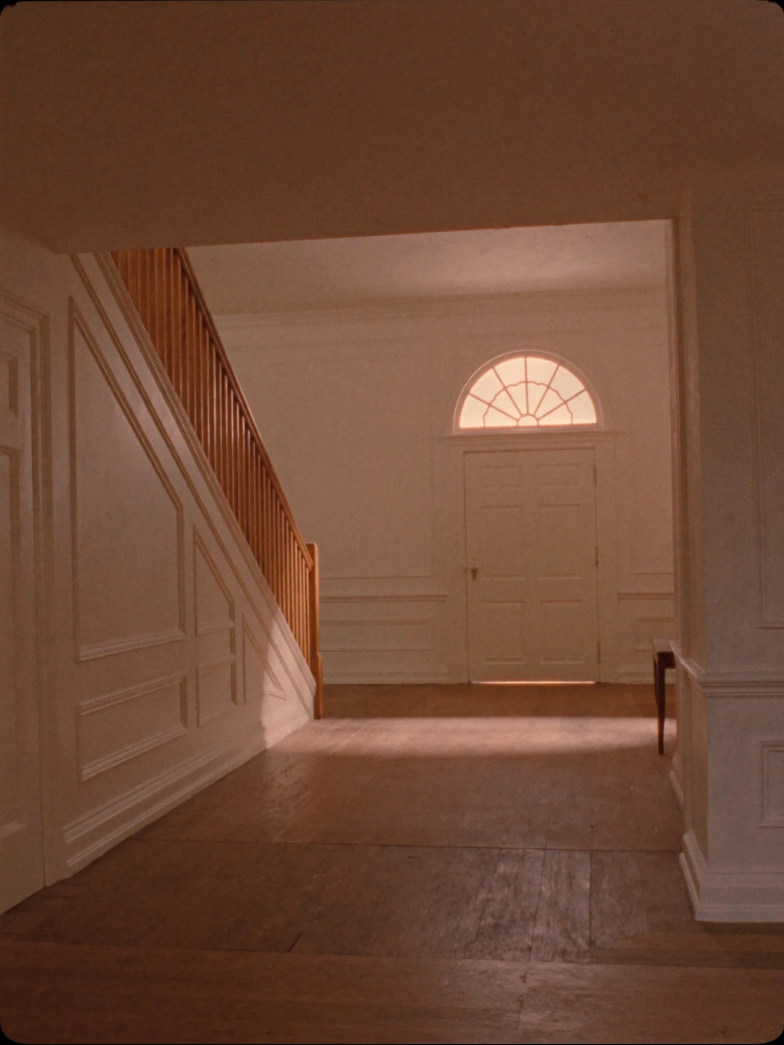 A quiet Georgian hallway with warm afternoon light, suggesting the calm of a chain-rescue cash sale