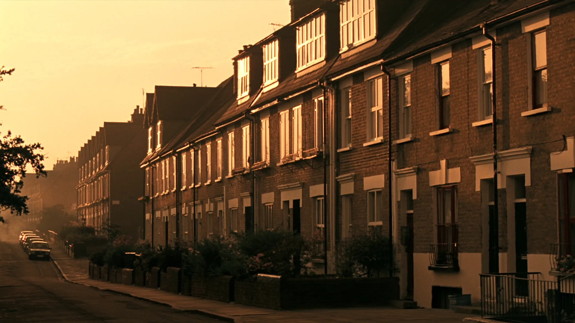 A quiet residential London Victorian terrace street at golden hour